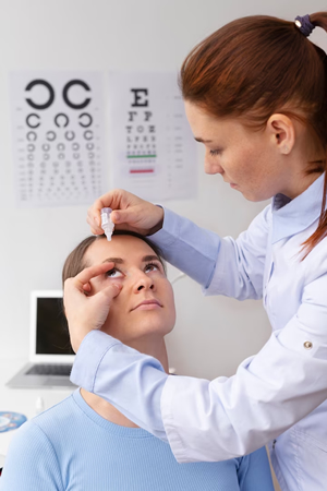 woman doctor inserting eye drops