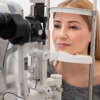 young woman looking into a vision testing machine
